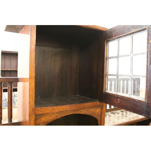 370 - Early 20th century oak sideboard, with lead glazed cupboard and shelves above central drawer, flanke... 