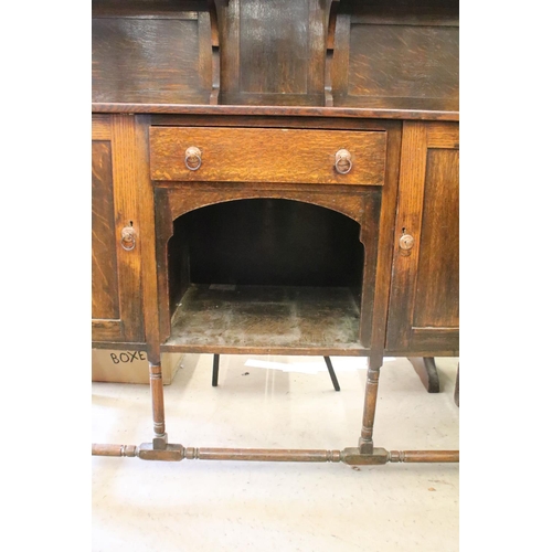 370 - Early 20th century oak sideboard, with lead glazed cupboard and shelves above central drawer, flanke... 