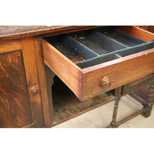 370 - Early 20th century oak sideboard, with lead glazed cupboard and shelves above central drawer, flanke... 