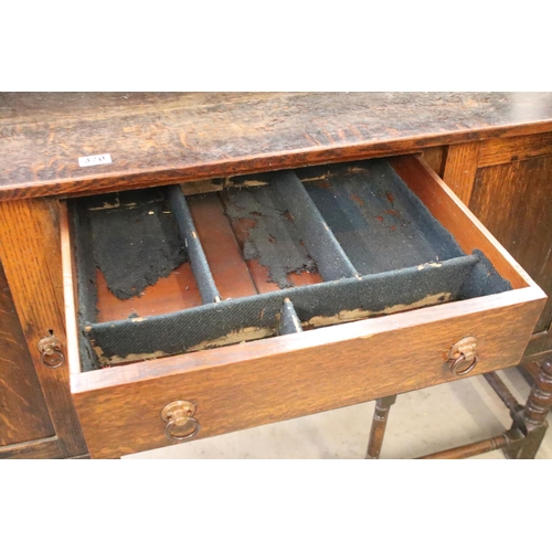 370 - Early 20th century oak sideboard, with lead glazed cupboard and shelves above central drawer, flanke... 