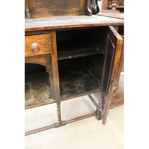 370 - Early 20th century oak sideboard, with lead glazed cupboard and shelves above central drawer, flanke... 