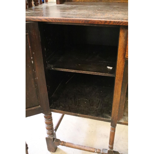 370 - Early 20th century oak sideboard, with lead glazed cupboard and shelves above central drawer, flanke... 