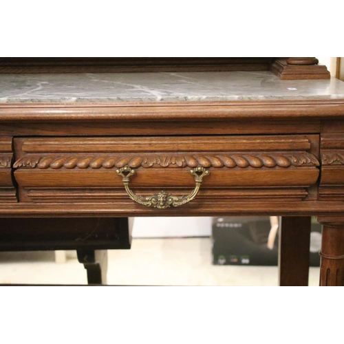 371 - Early 20th century carved oak sideboard, with carved pediment, galleried shelf and marble top, above... 