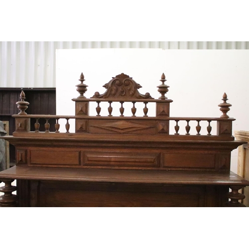 371 - Early 20th century carved oak sideboard, with carved pediment, galleried shelf and marble top, above... 