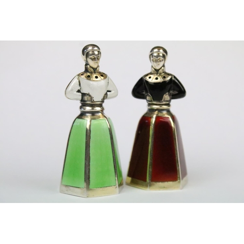 46 - Two Norwegian silver Jacob Tostrup enamel pepper shakers in the form of ladies to include a Red / Bl... 