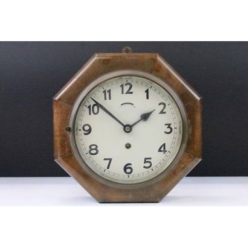 54 - Art Deco oak cased octagonal wall clock with cream dial, Arabic numerals and poker hands. Measures 2... 