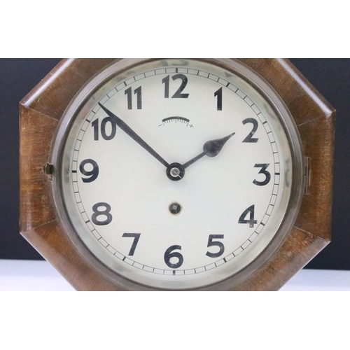 54 - Art Deco oak cased octagonal wall clock with cream dial, Arabic numerals and poker hands. Measures 2... 