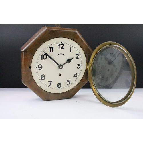 54 - Art Deco oak cased octagonal wall clock with cream dial, Arabic numerals and poker hands. Measures 2... 