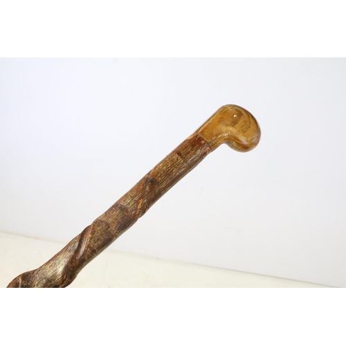 55 - Vintage wooden walking stick of spiralling form, approx 102cm long