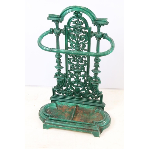 56 - Green painted cast iron stick stand with pierced scrolling classical design, approx 70cm tall