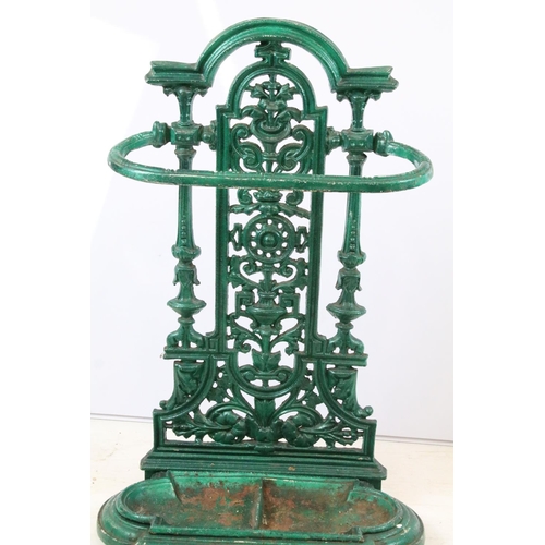 56 - Green painted cast iron stick stand with pierced scrolling classical design, approx 70cm tall