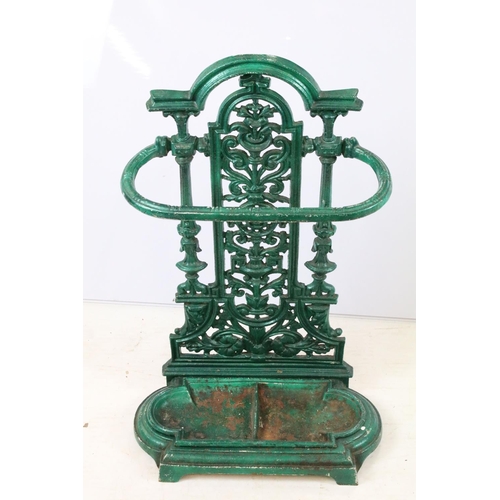 56 - Green painted cast iron stick stand with pierced scrolling classical design, approx 70cm tall