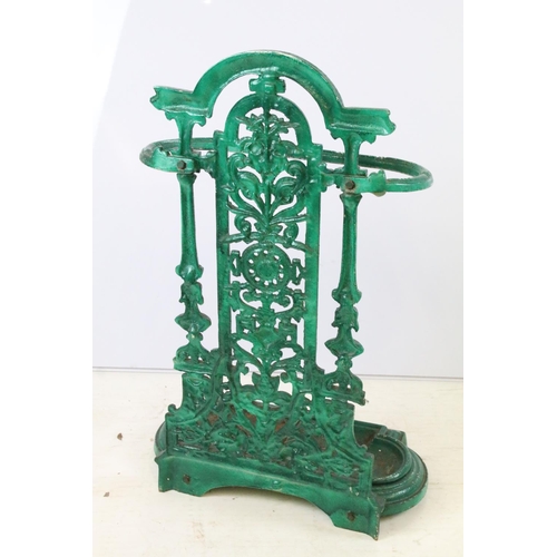 56 - Green painted cast iron stick stand with pierced scrolling classical design, approx 70cm tall