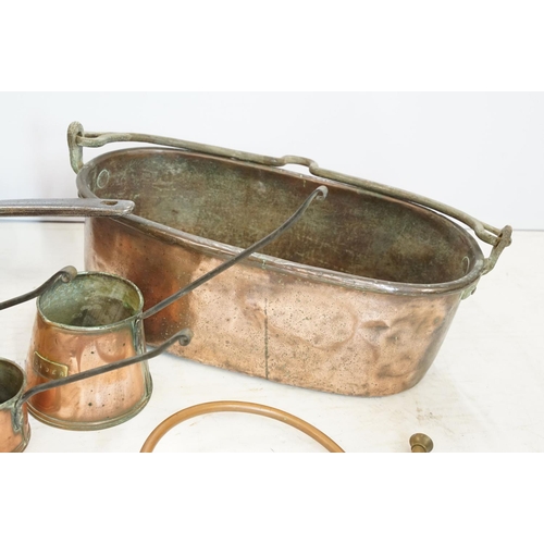 282 - A collection of mixed copper ware to include kettle, saucepan, ladles, jug...etc.