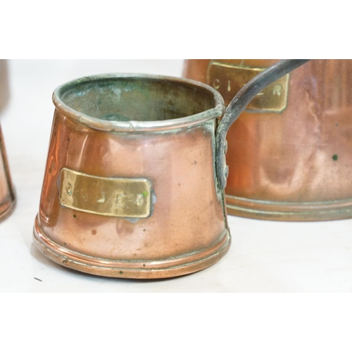 282 - A collection of mixed copper ware to include kettle, saucepan, ladles, jug...etc.