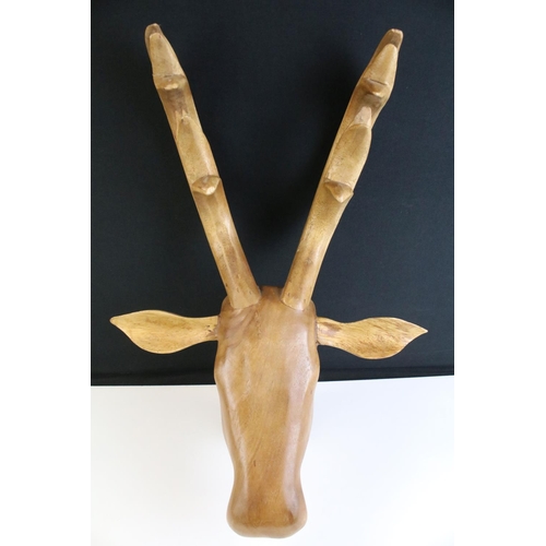 104 - Wooden carved hanging stags head, 47cm high