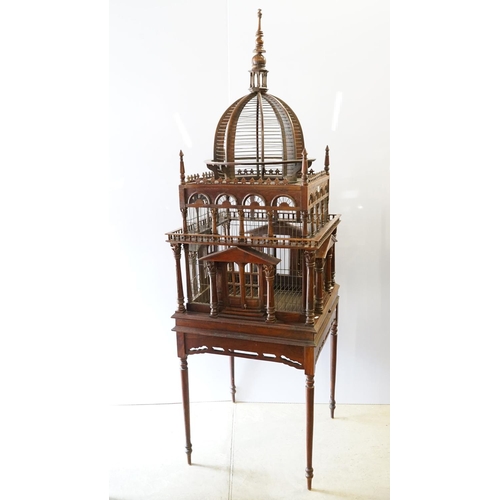 369 - Ornamental mahogany bird cage in the form of a building, on stand, approximately 216cm high x 67.5cm... 