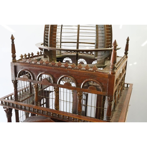 369 - Ornamental mahogany bird cage in the form of a building, on stand, approximately 216cm high x 67.5cm... 