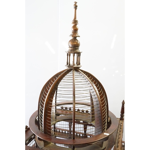 369 - Ornamental mahogany bird cage in the form of a building, on stand, approximately 216cm high x 67.5cm... 