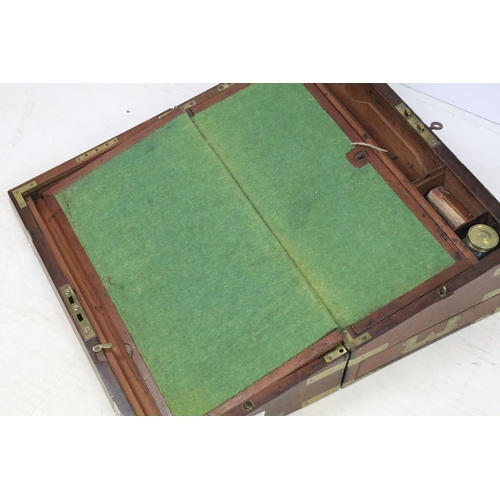 295 - A mahogany brass banded writing slope with fitted interior together with another writing slope.