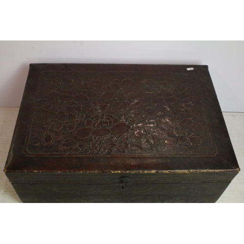 299 - Early 20th century leatherette twin-handled trunk, embossed with flowers and foliage, 26cm high x 65... 