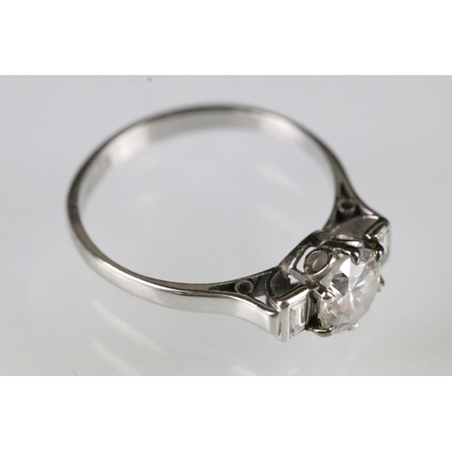 42 - Platinum and diamond three stone ring being set with a round brilliant cut diamond to centre flanked... 