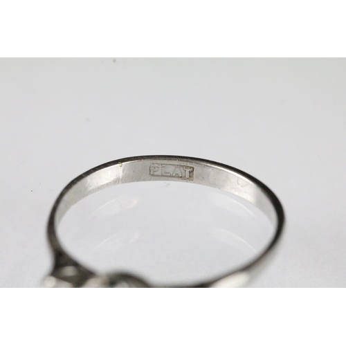 42 - Platinum and diamond three stone ring being set with a round brilliant cut diamond to centre flanked... 