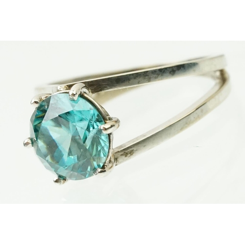 14 - 18ct white gold and zircon dress ring. The ring being set with a round brilliant cut blue zircon pro... 