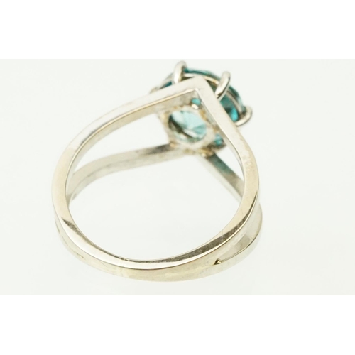 14 - 18ct white gold and zircon dress ring. The ring being set with a round brilliant cut blue zircon pro... 