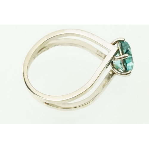 14 - 18ct white gold and zircon dress ring. The ring being set with a round brilliant cut blue zircon pro... 