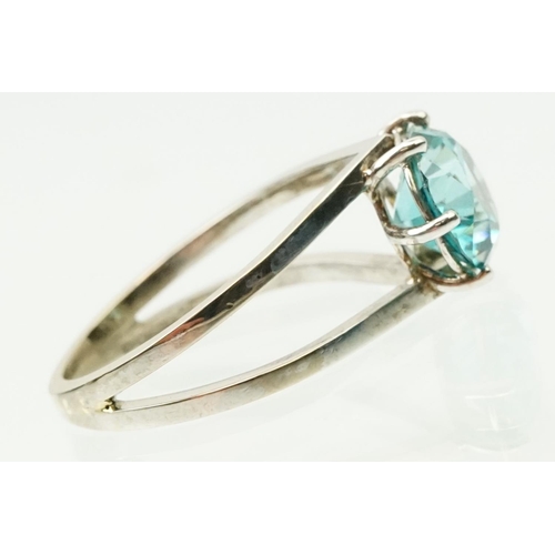 14 - 18ct white gold and zircon dress ring. The ring being set with a round brilliant cut blue zircon pro... 