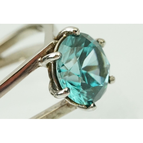 14 - 18ct white gold and zircon dress ring. The ring being set with a round brilliant cut blue zircon pro... 