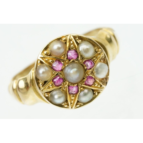 44 - 19th Century Victorian ruby and pearl ring. The ring having a round head with half pearls and six cu... 