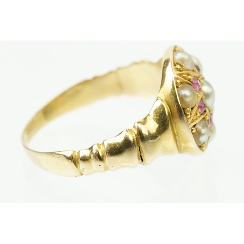 44 - 19th Century Victorian ruby and pearl ring. The ring having a round head with half pearls and six cu... 