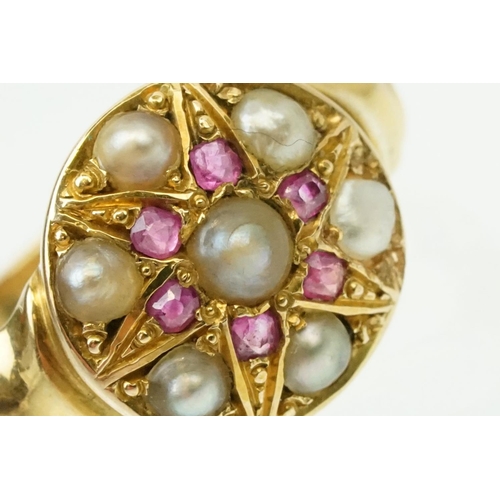 44 - 19th Century Victorian ruby and pearl ring. The ring having a round head with half pearls and six cu... 