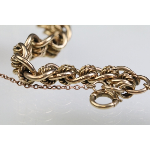 12 - 9ct gold fancy link bracelet chain having contrasting curb links and rope twist links with a tiger e... 