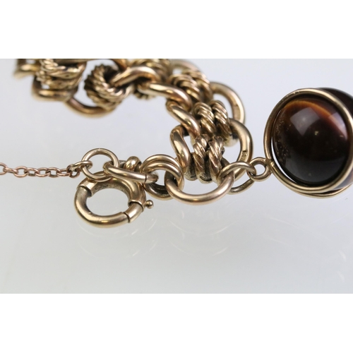 12 - 9ct gold fancy link bracelet chain having contrasting curb links and rope twist links with a tiger e... 