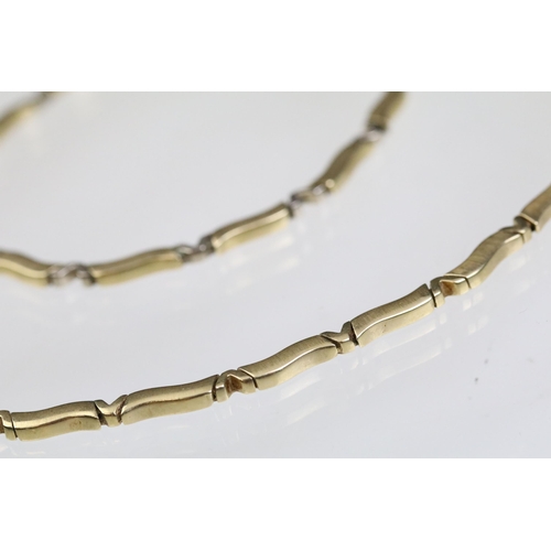24 - 14ct gold necklace and bracelet suite each having curved bar links with v shaped spacer links. Marke... 