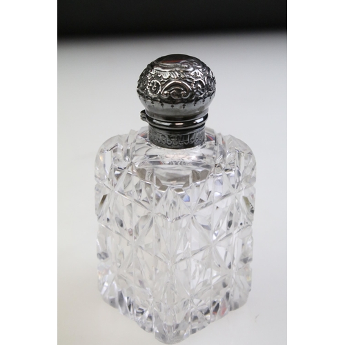 490 - Group of silver topped cut glass scent bottles including four of orb form and one square example. Ea... 