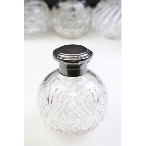 490 - Group of silver topped cut glass scent bottles including four of orb form and one square example. Ea... 