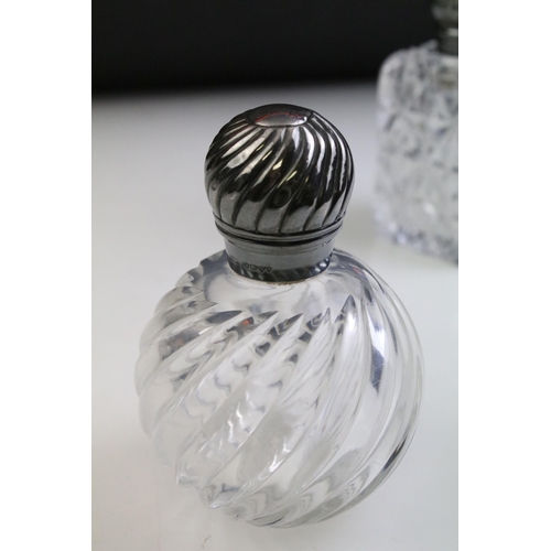 490 - Group of silver topped cut glass scent bottles including four of orb form and one square example. Ea... 