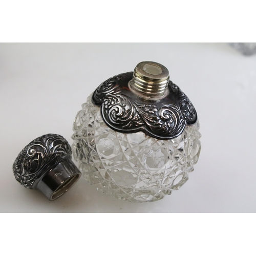 490 - Group of silver topped cut glass scent bottles including four of orb form and one square example. Ea... 