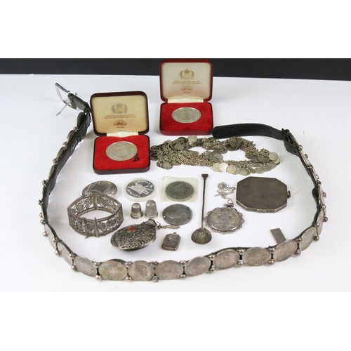 161 - A collection of coins and medallions, some silver examples, coin belt, brooch, silverware....etc..