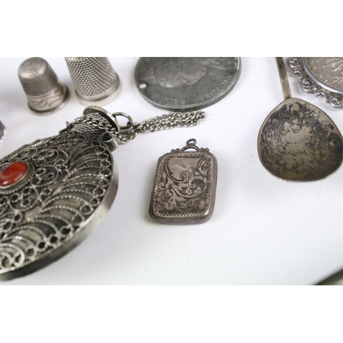 161 - A collection of coins and medallions, some silver examples, coin belt, brooch, silverware....etc..