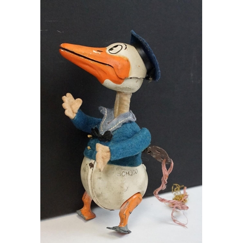 327 - Original Mid 20th C Schuco clockwork tin plate Donald Duck toy, with key, showing some wear and grub... 