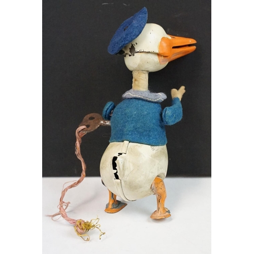 327 - Original Mid 20th C Schuco clockwork tin plate Donald Duck toy, with key, showing some wear and grub... 