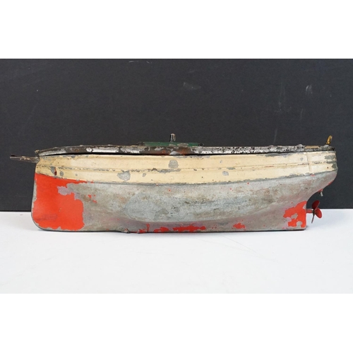 330 - Antique tin plate paddle wheel steam boat with handle and a metal painted motor boat, both showing w... 