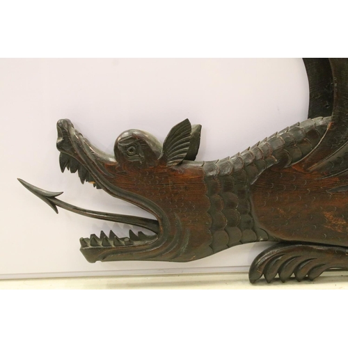 106 - Large wooden carving of a dragon with flamed tongue and carved scale detail. 36cm x 78cm