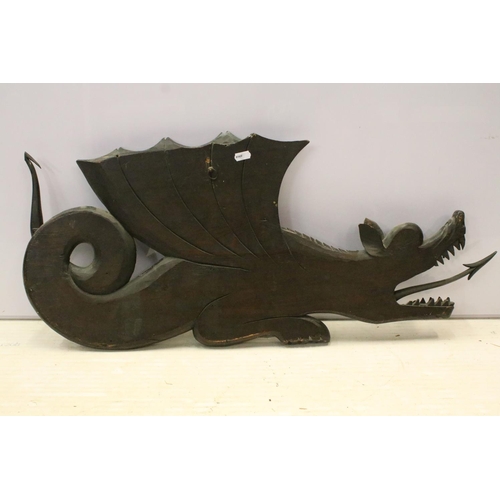 106 - Large wooden carving of a dragon with flamed tongue and carved scale detail. 36cm x 78cm