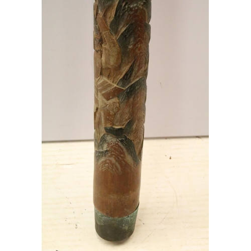 133 - Large carved Oriental Malacca decorative staff post with wolf and warrior scene.